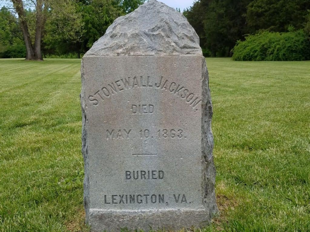 A stone monument noting the deathplace of Stonewall Jackson in May of 1863. A plain gray granite rough-cut stone.