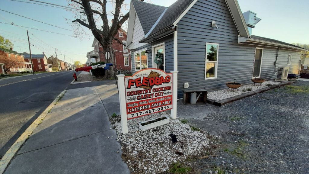 The Feedbag sign with the gray restaurant in Fairfield in the background.