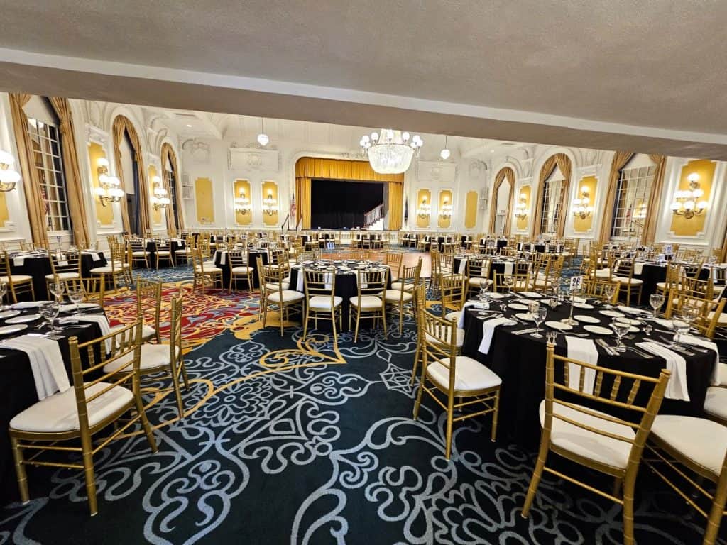 The Grand Ballroom at the Jefferson Hotel set up for an event, with blue carpet and formal round tables.
