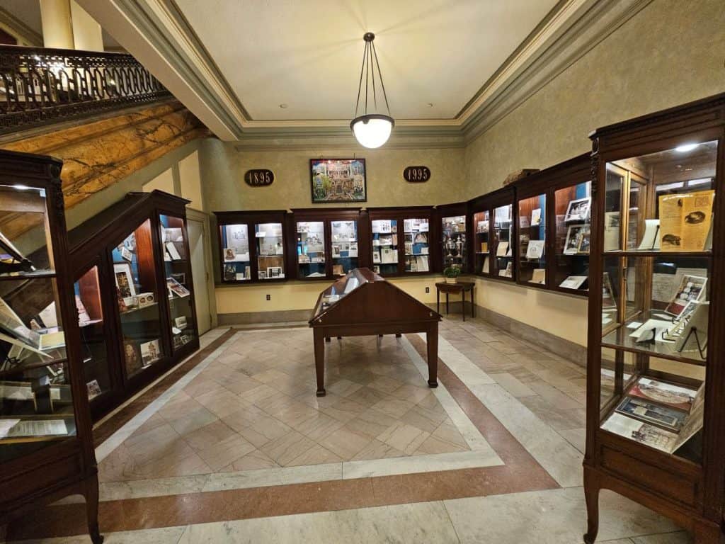 The historical exhibit space at The Jefferson Hotel shows glass cases with historical memorabilia inside.