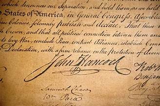 An aged-looking photo of the Declaration with a closeup of John Hancock's signature.
