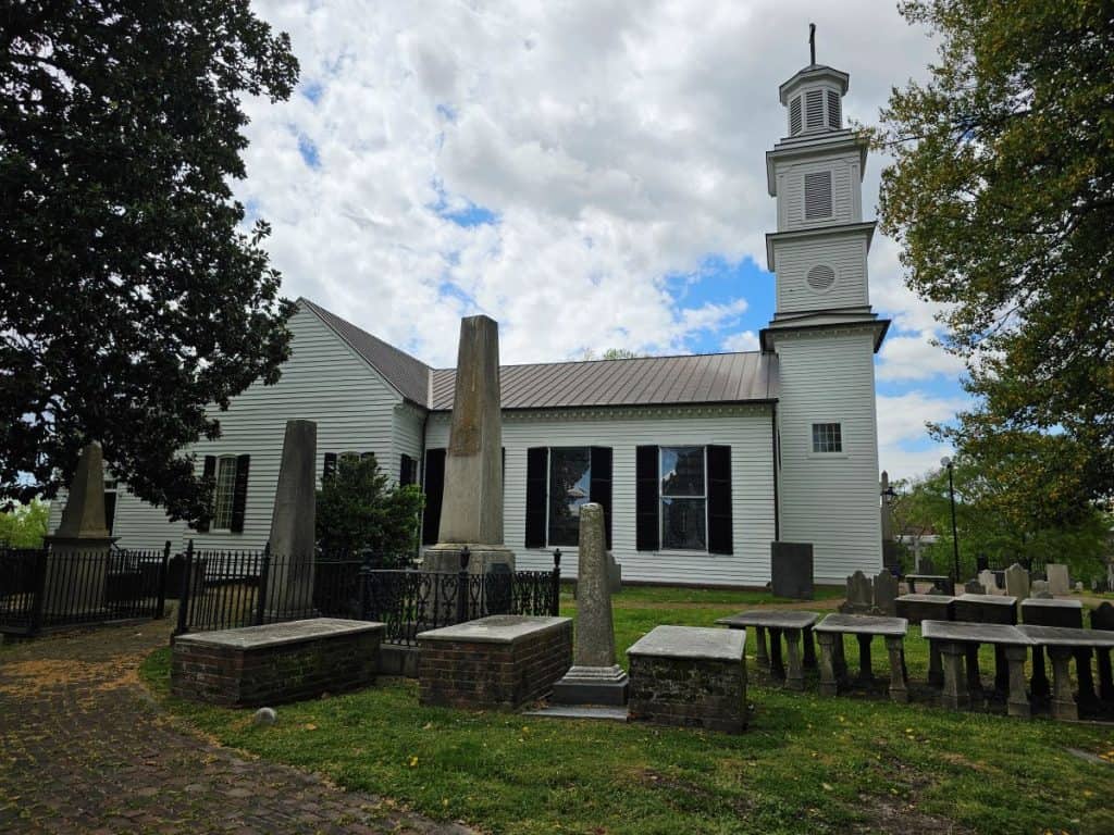 A side view of St Johns Church Richmond with some historic tombstones.