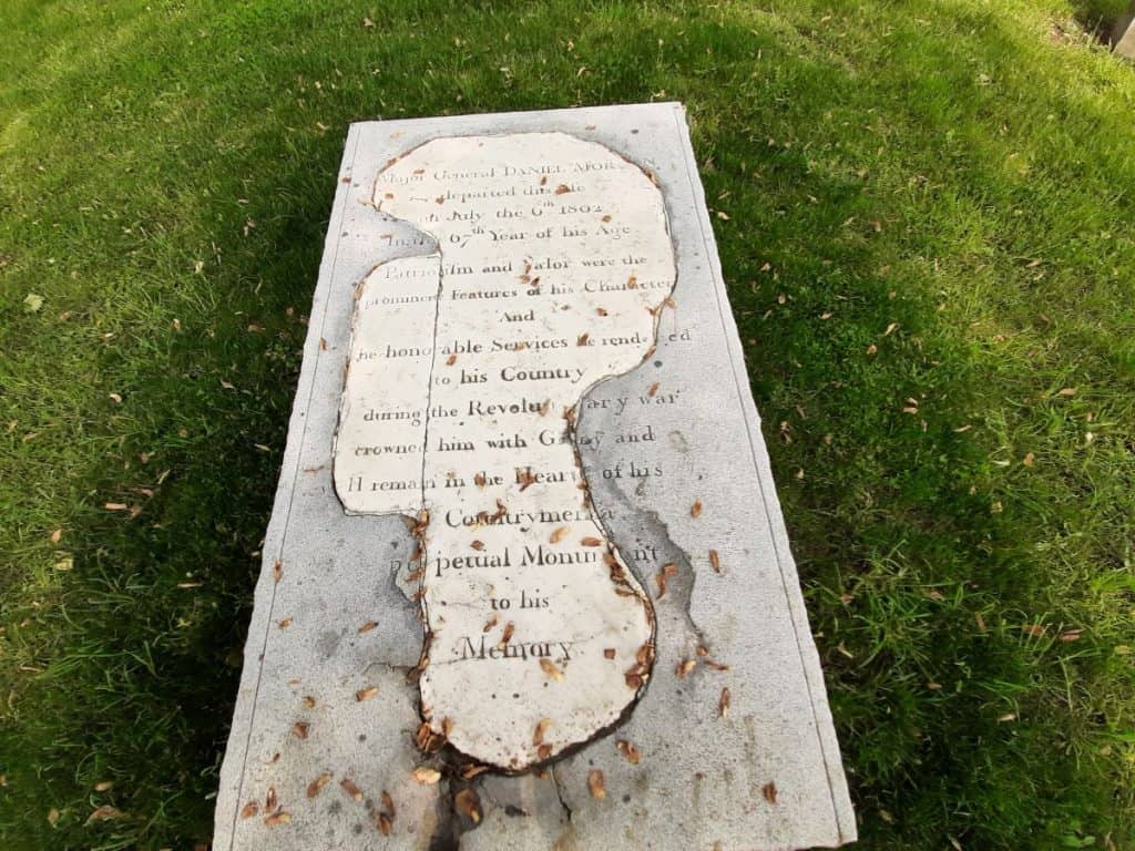 A marble slab that marks the gravesite of General Daniel Morgan. It shows obvious signs of repair.