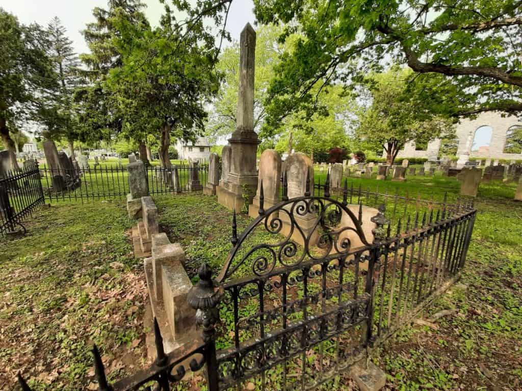 Old wrought iron fencing surrounds a family plot in the Mount Hebron Cemetery.