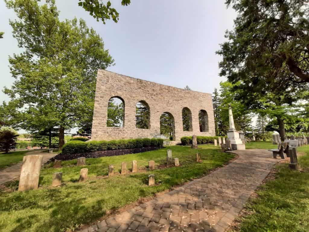 The Old Church Wall with a brick sidewalk leading up to it.