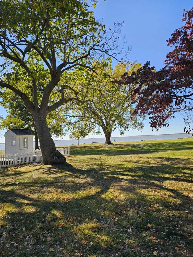 Battery Park in historic New Castle De shows trees and water in the background.