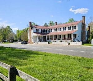 Hanover Tavern in Virginia is a two story white building with a chimney on each end.