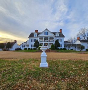 The magnificent Inn at Warner Hall under a blue cloudy sky.