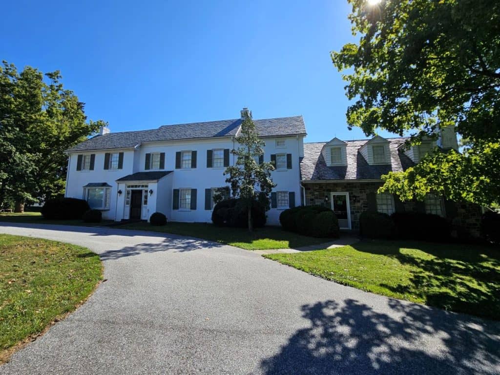 The home of Ike and Mamie Eisenhower is a white two-story home with black shutters. It is a great place to visit in Spring in Gettysburg.