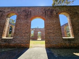 The sun shines through the brick remains of a church that was burned by the British during the Revolutionary War in Brunswick Town, N.C.
