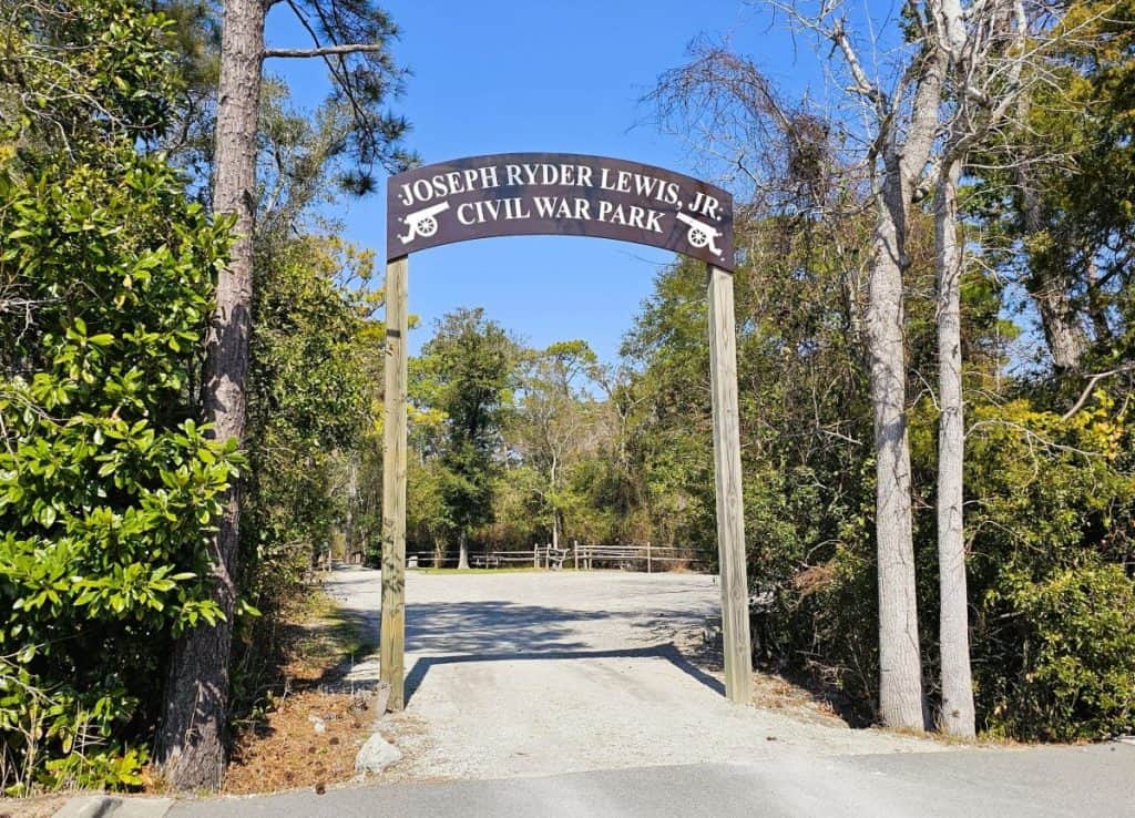 A brown sign with white lettering that says Joseph Ryder Lewis Civil War Park.