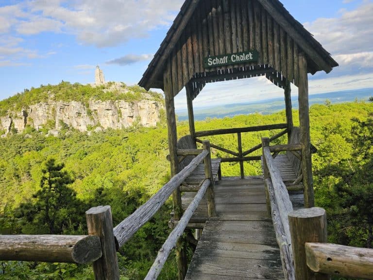 A Mohonk Mountain House summerhouse seems to sit in the sky, overlooking cliffs and mountains.