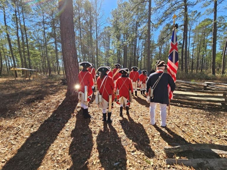 British soldiers wearing red coats are lined up at Moore's Creek Bridge Battlefield during the 249th anniversary event.