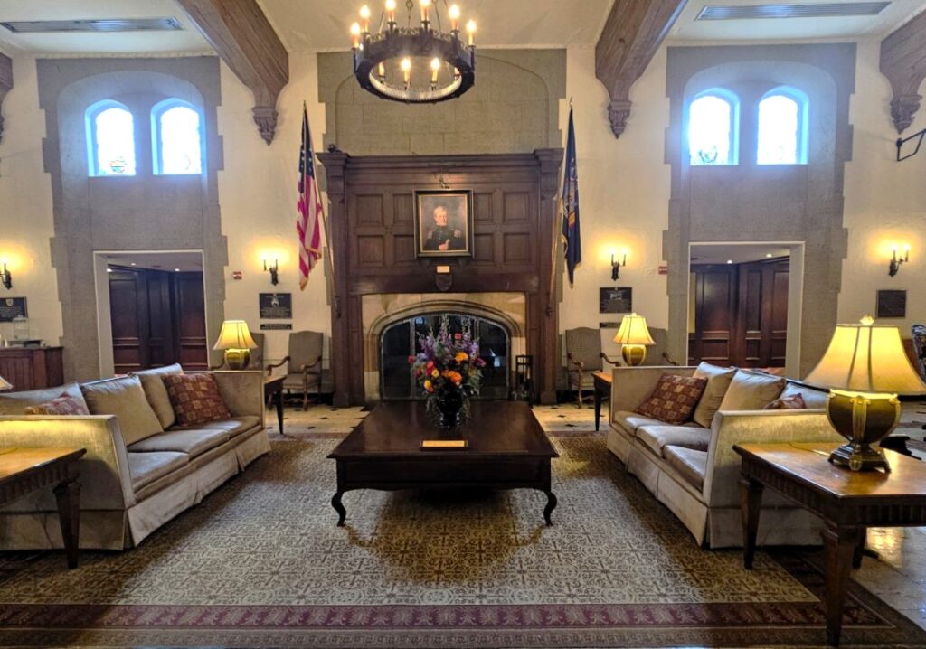 The lobby of The Thayer Hotel in West Point with chandelier and sitting area.