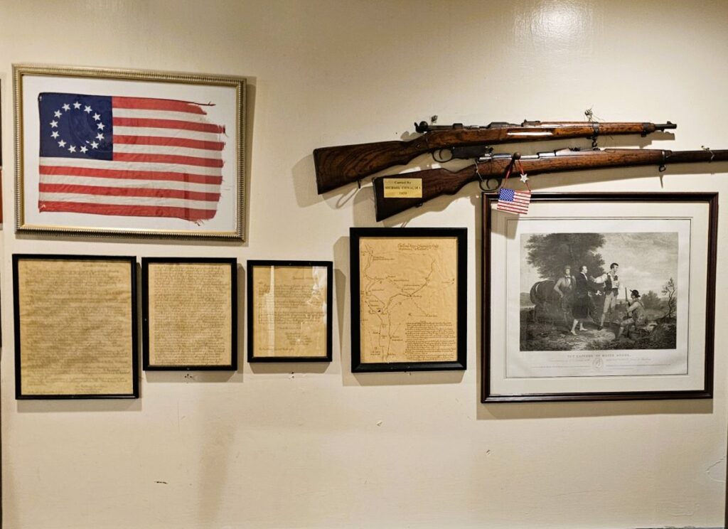 Historical artifacts hang on the wall of the Old 76 House relating to the Revolutionary War and America's founding