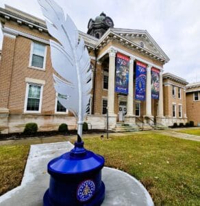 A huge quill feather in blue inkwell stands in front the Halifax Courthouse in North Carolina.