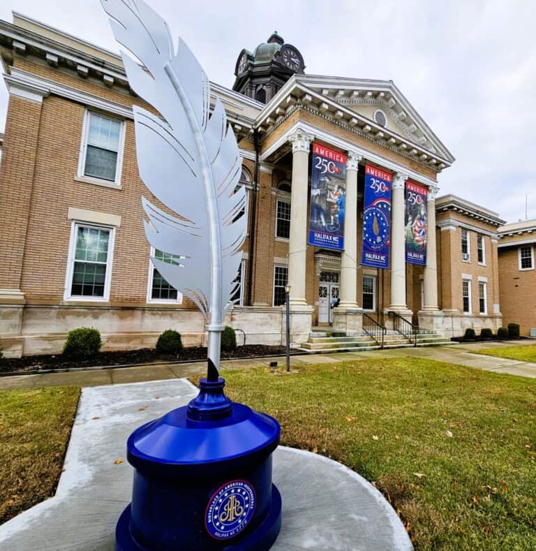A huge quill feather in blue inkwell stands in front the Halifax Courthouse in North Carolina.