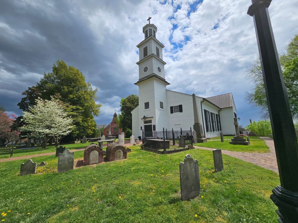 St. John's Church where Patrick Henry gave his famous address is a white church with a tall steeple.