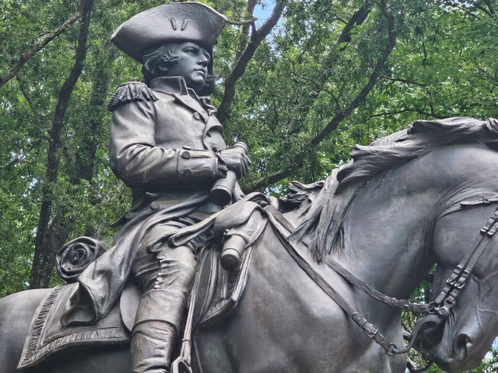 Revolutionary War monument with officer on a horse.