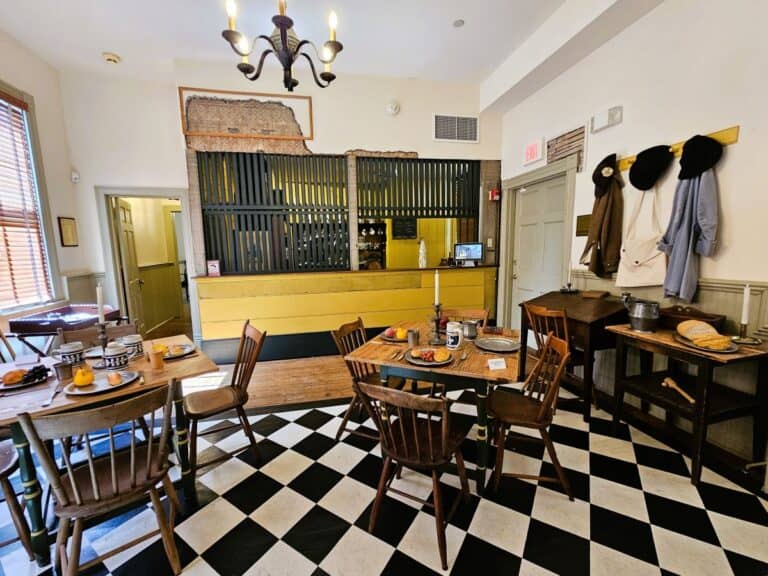 One of the historic taverns in Virginia the Hanover Tavern, with checkerboard floor, wooden tables and yellow bar area.