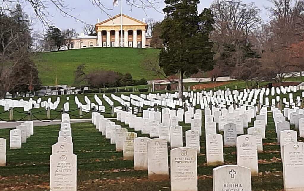 Arlington House on a hill with the graves of Arlington Cemetery in the foreground.
